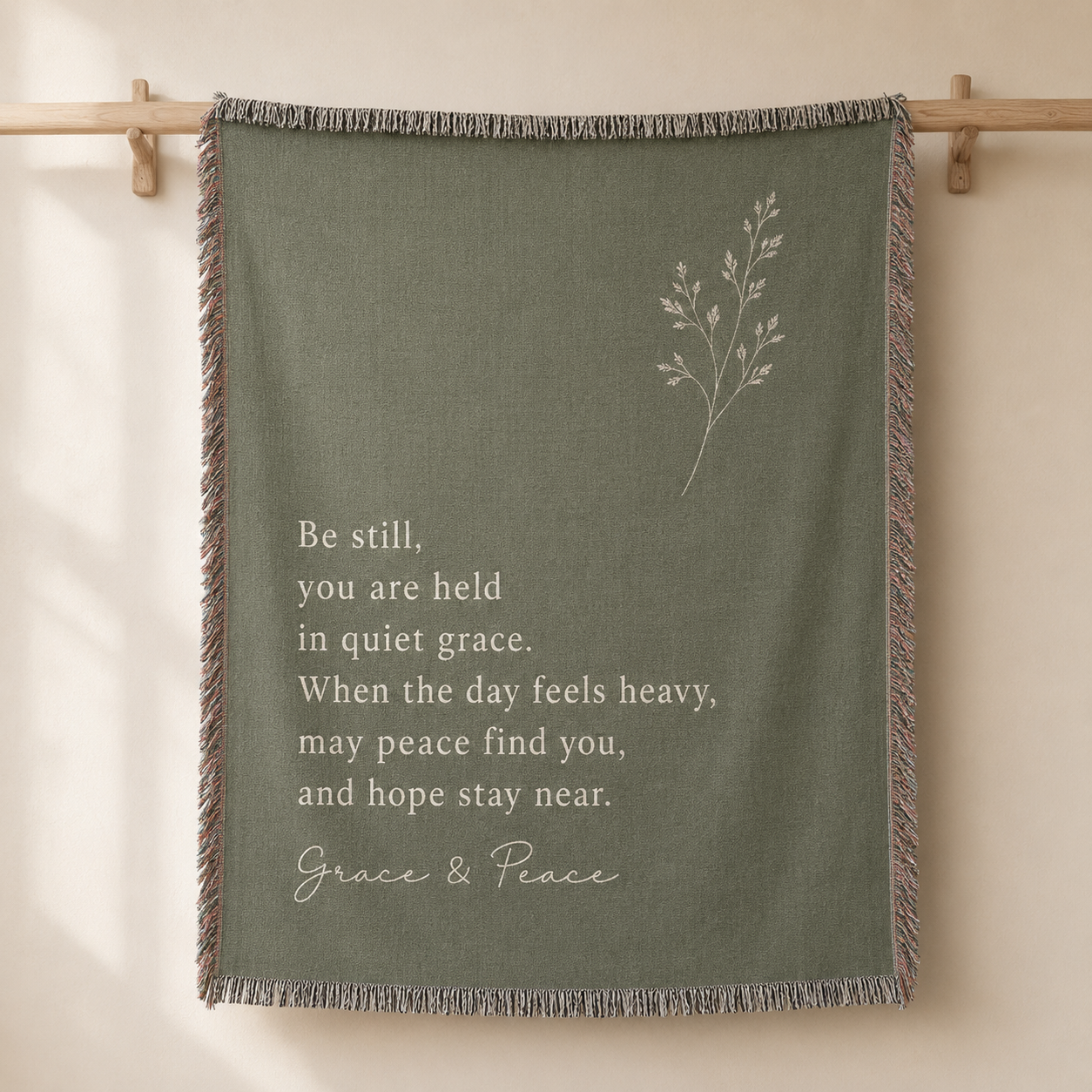 Grace and Peace sage green inspirational woven blanket displayed as a wall tapestry
