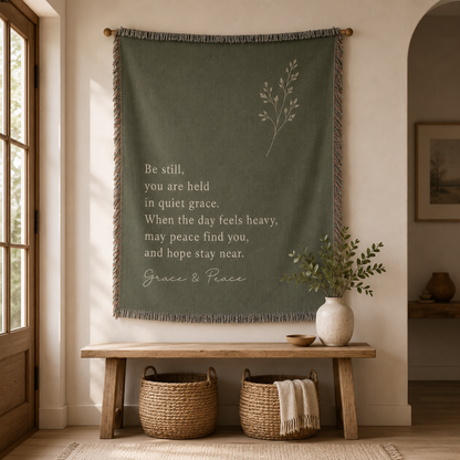 Grace and Peace sage green inspirational woven blanket hanging as wall decor above a bench