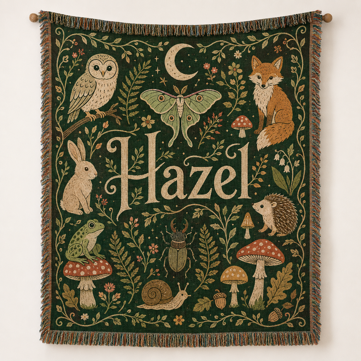 Personalized woodland name woven blanket with forest animals and mushrooms displayed as a tapestry