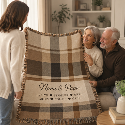 Granddaughter gifting a personalized Nana and Papa plaid woven blanket to grandparents