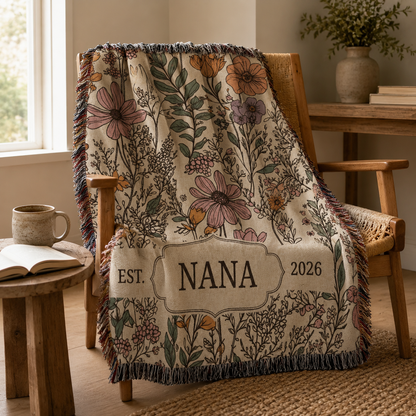 Personalized Nana wildflower woven blanket draped over a cozy wooden reading chair