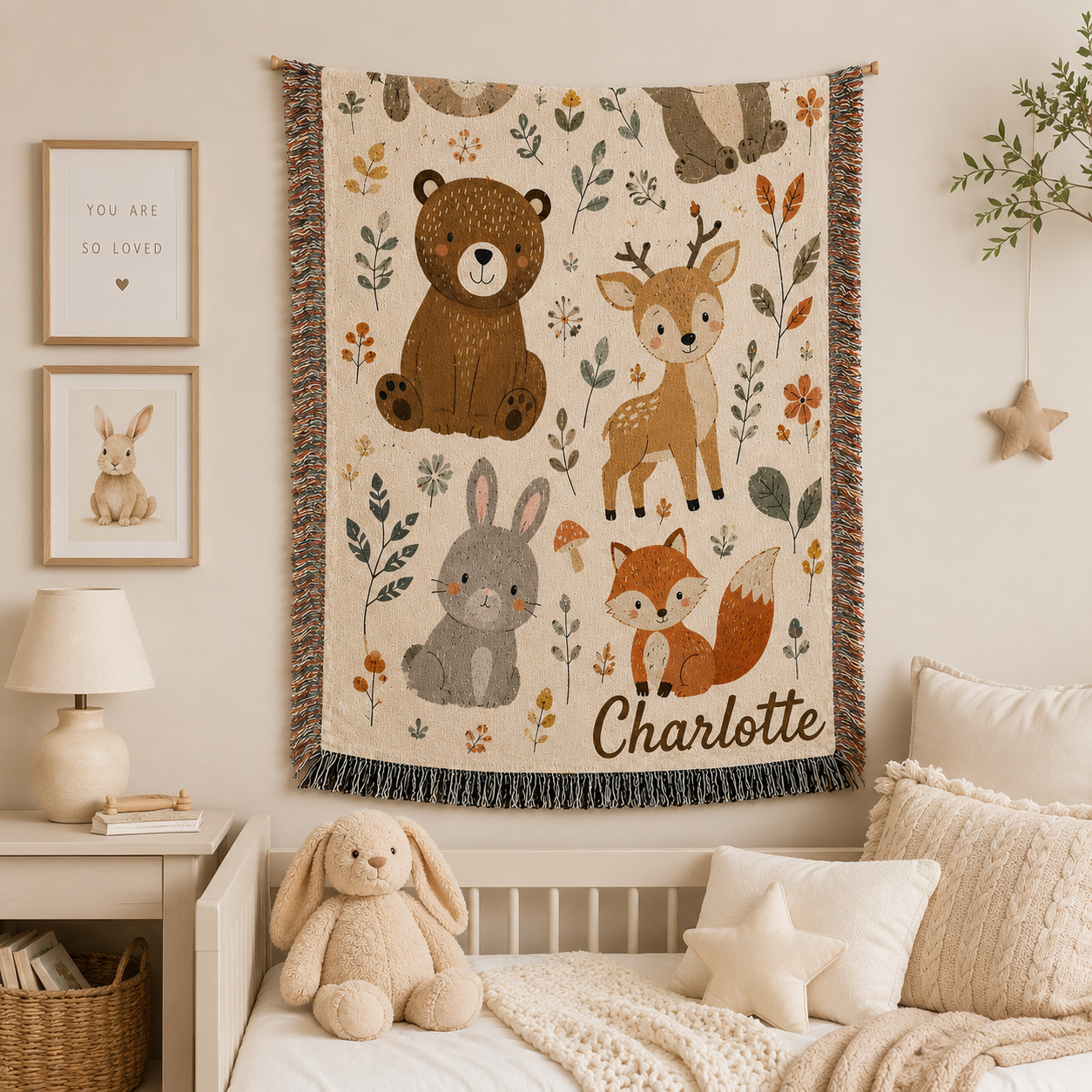 Woodland animals woven blanket flat lay with nursery toys