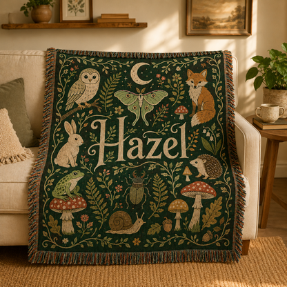Personalized woodland name woven blanket draped over a cream sofa in a warm living room