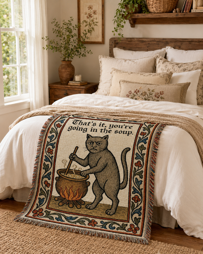 Funny medieval cat woven blanket in a cozy bedroom